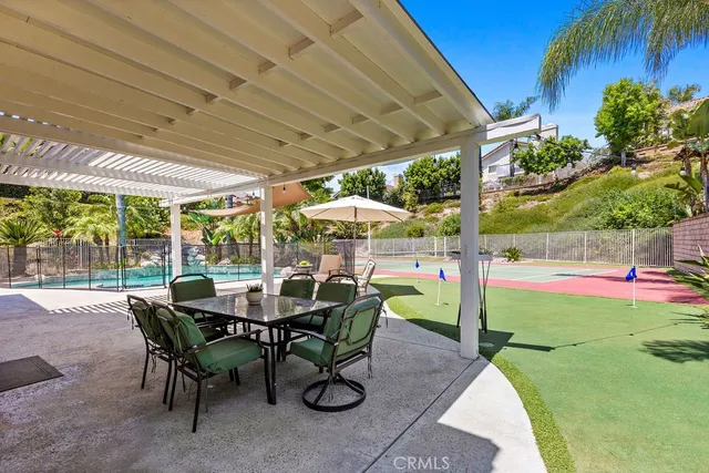 a view of an outdoor dining space with a table and chairs