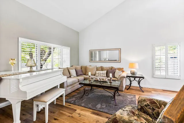 a living room with furniture large window and a table
