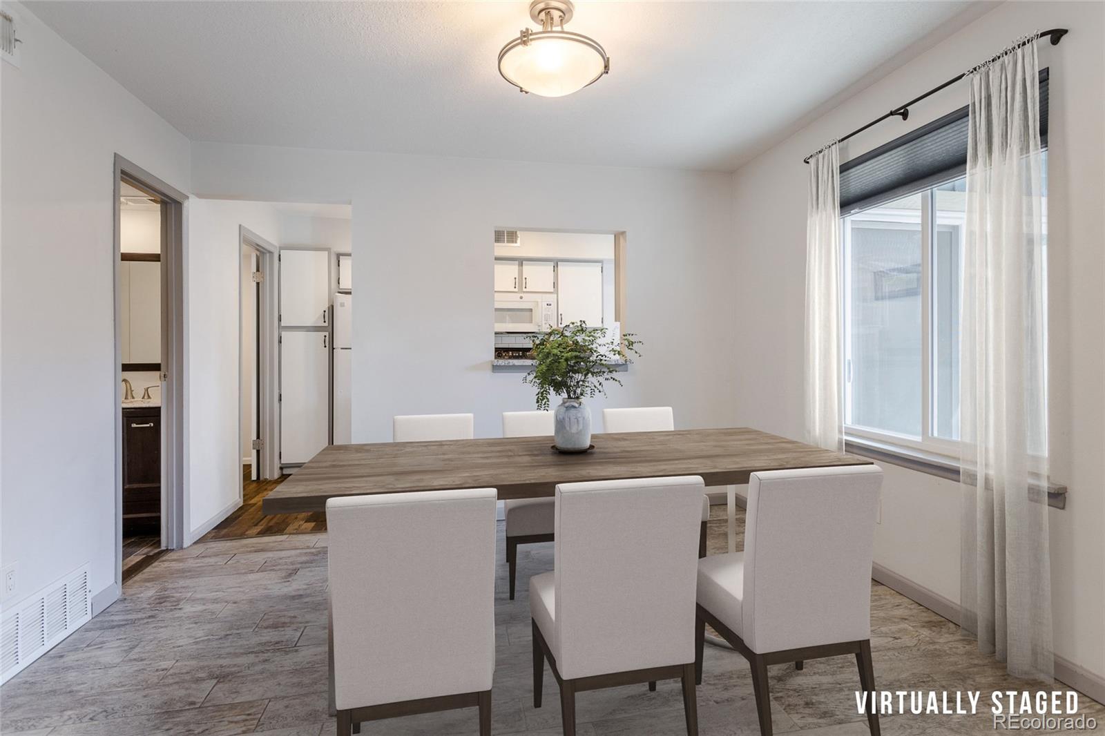 12143 Bannock Street, Unit B Denver, CO 80234 - Photo 11 of 32 a dining room with furniture and window