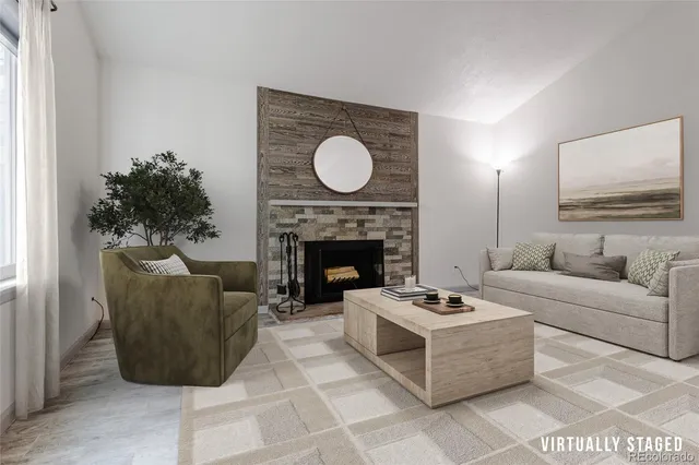 a living room with furniture a fireplace and a potted plant