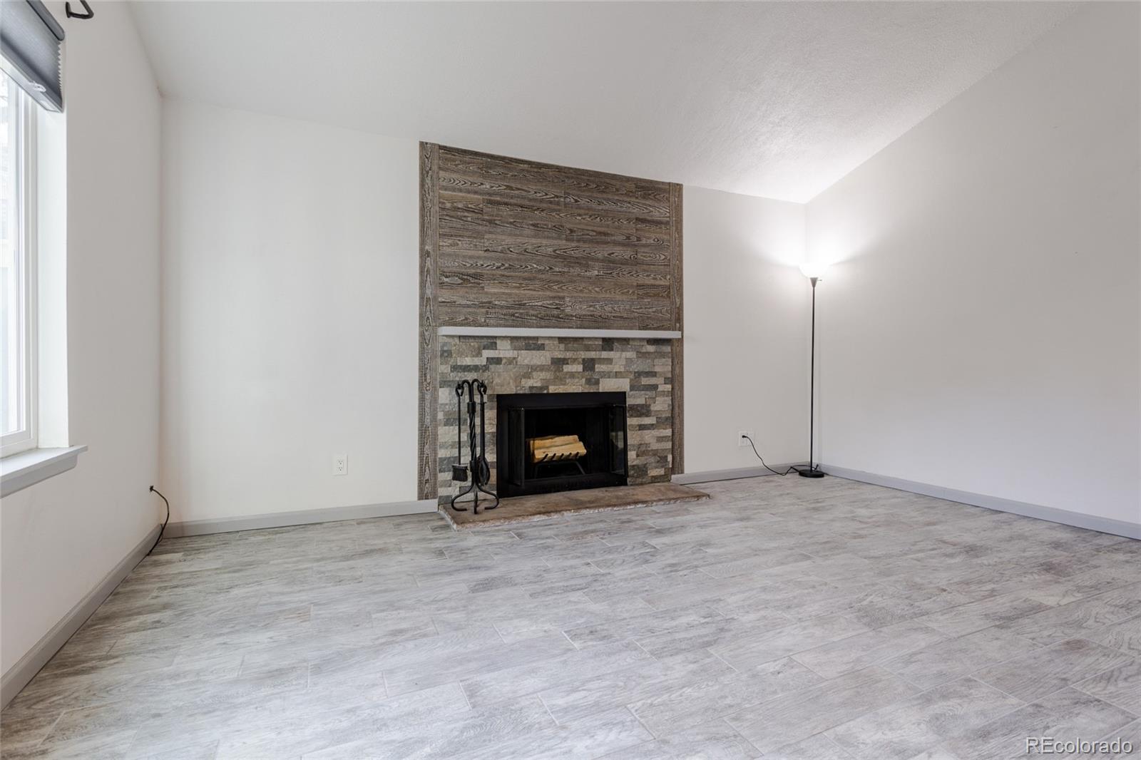 12143 Bannock Street, Unit B Denver, CO 80234 - Photo 6 of 32 a view of an empty room with a fireplace