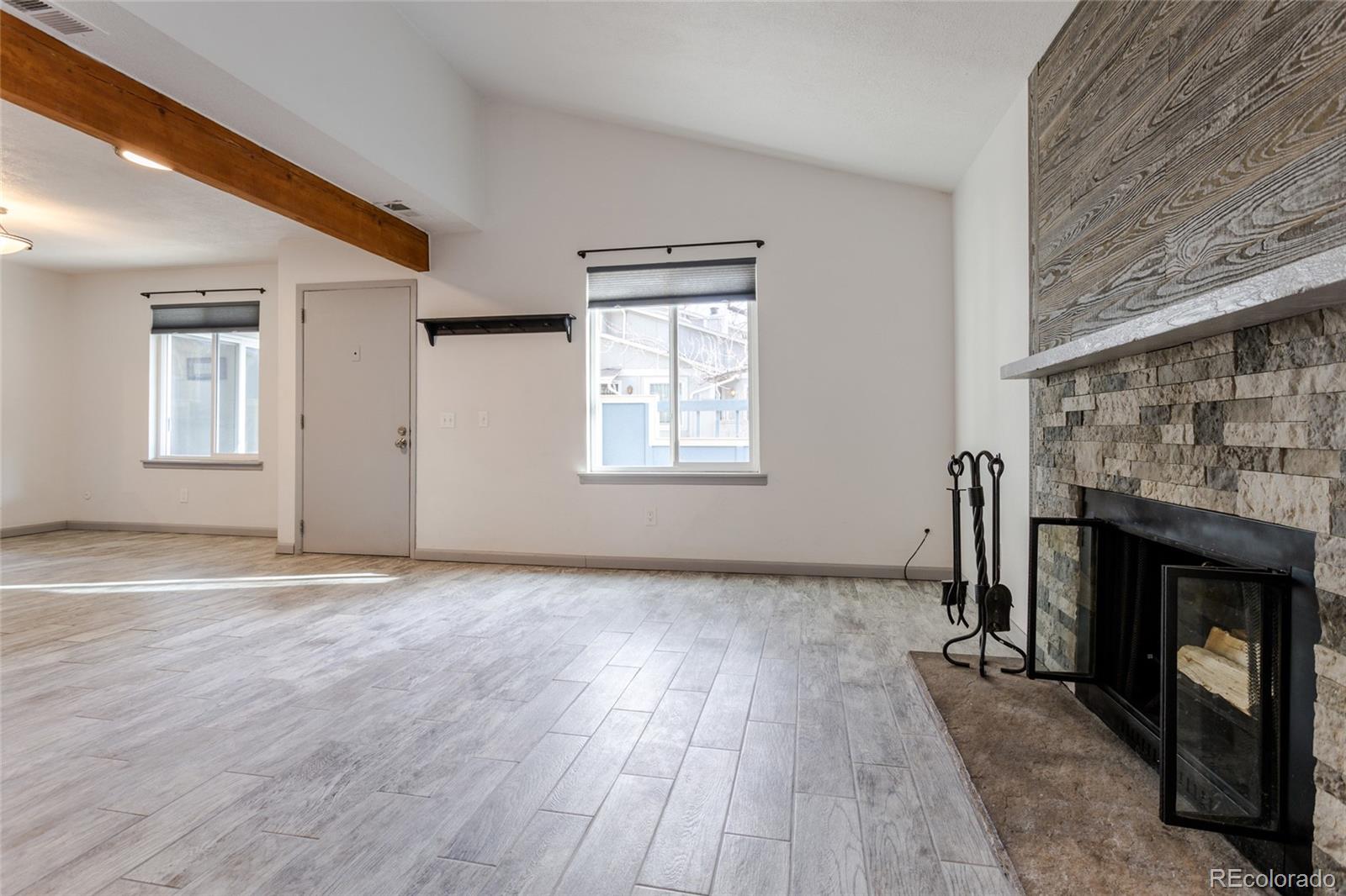 12143 Bannock Street, Unit B Denver, CO 80234 - Photo 7 of 32 an empty room with windows and fireplace