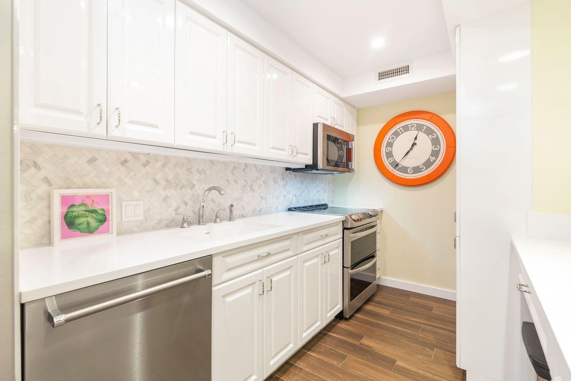 170 Chilean Avenue, Unit 2D Palm Beach, FL 33480 - Photo 11 of 29 a kitchen with a stove and a white refrigerator