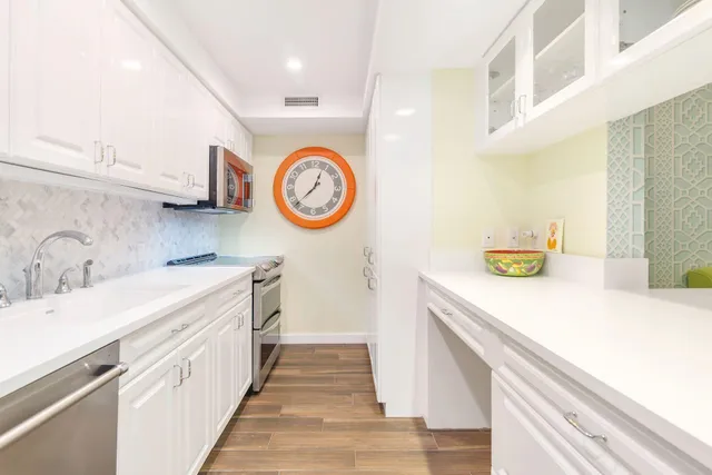 a kitchen with a sink and a stove top oven