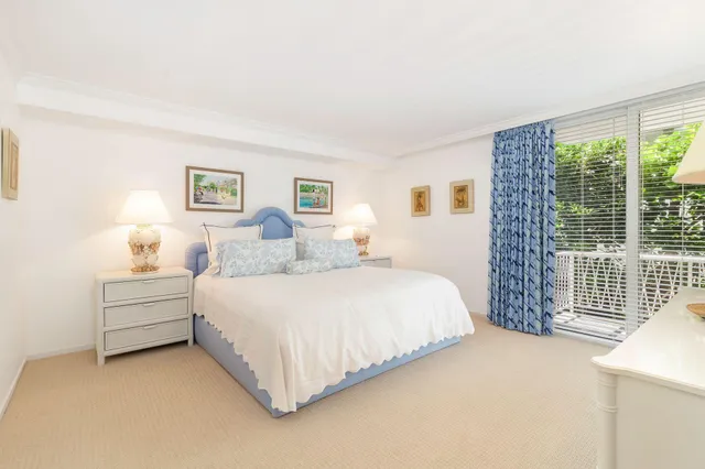 a bedroom with bed and a large window