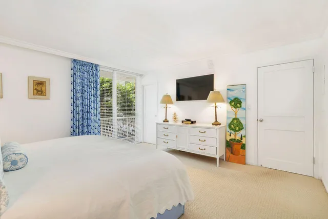 a bedroom with furniture and flat screen tv