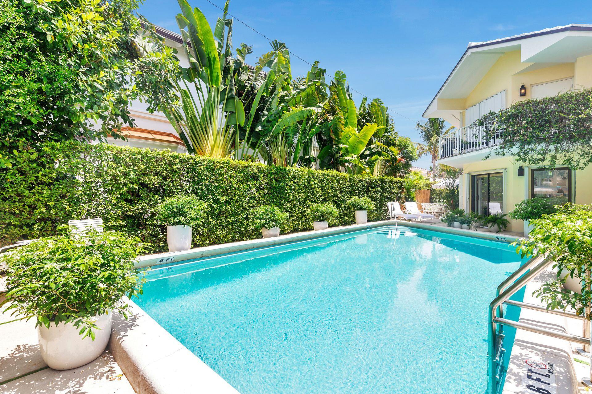 170 Chilean Avenue, Unit 2D Palm Beach, FL 33480 - Photo 22 of 29 a view of a swimming pool with potted plants