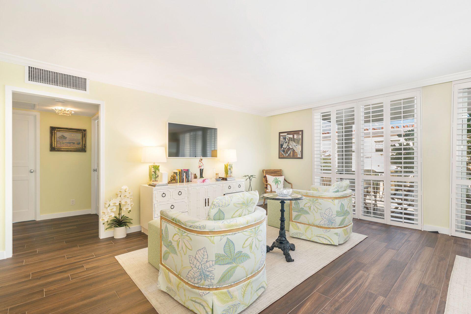 170 Chilean Avenue, Unit 2D Palm Beach, FL 33480 - Photo 4 of 29 a living room with fireplace furniture and a wooden floor