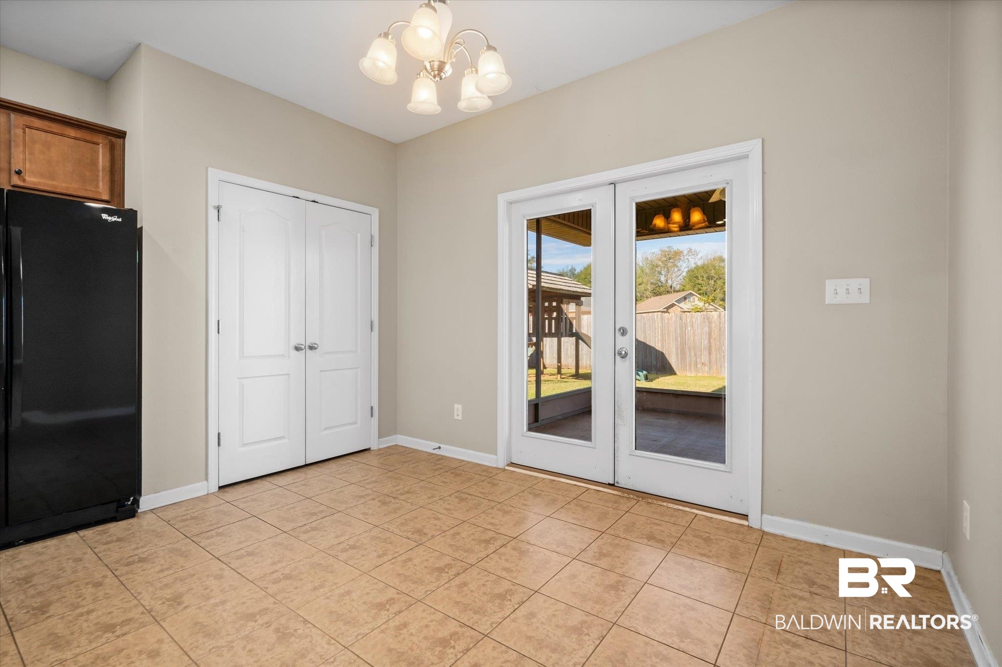 10251 Fionn Loop Daphne, AL 36526 - Photo 8 of 28 Interior space featuring light tile patterned floors, french doors, and a chandelier