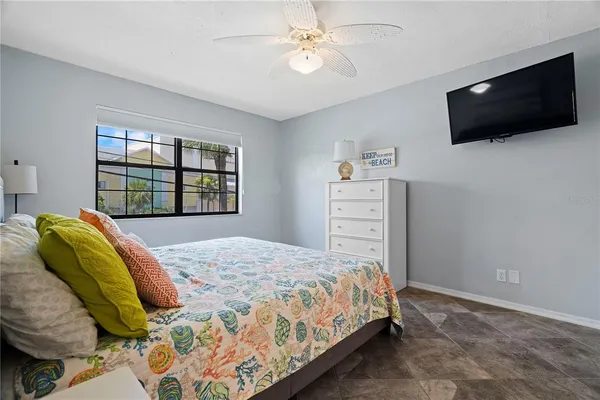 a bedroom with a bed and a flat screen tv