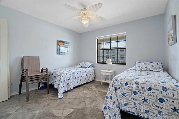 a bedroom with two beds and a window