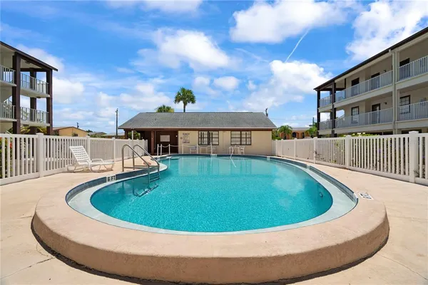 a view of a house with swimming pool and sitting area