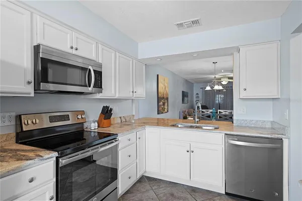 a kitchen with a sink stove and microwave