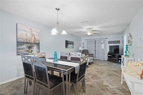 a view of a dining room with furniture and a chandelier