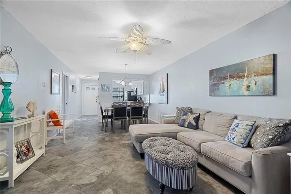 a living room with furniture and a chandelier