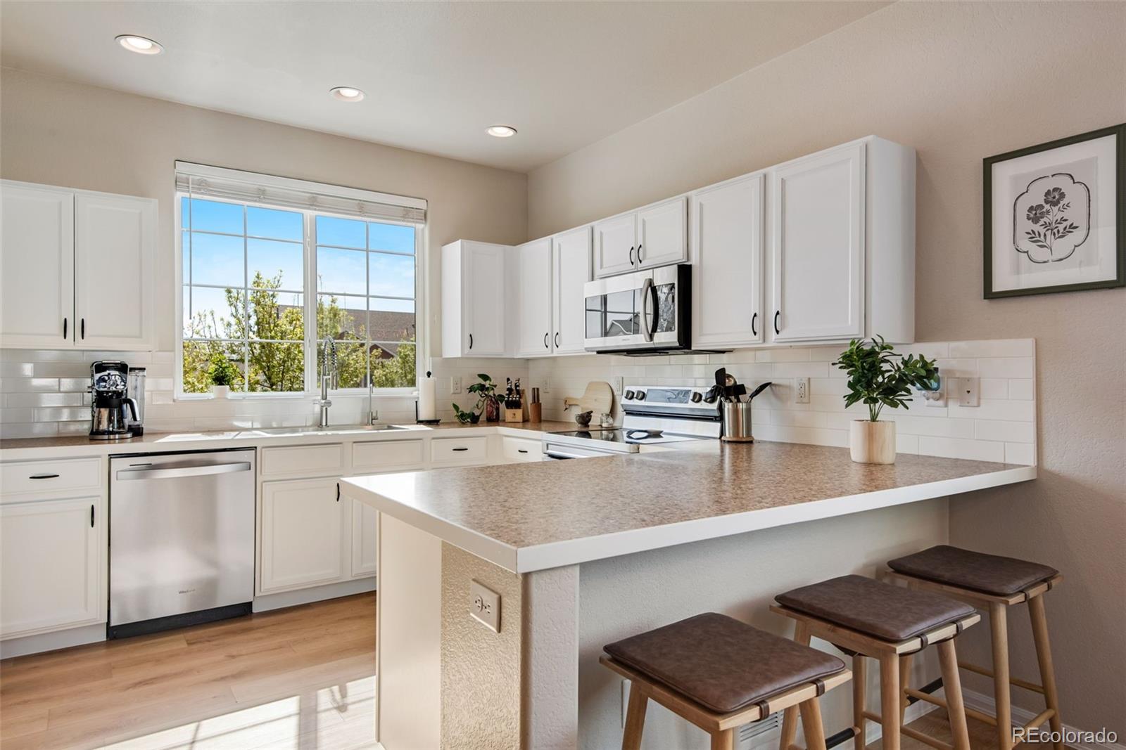 7035 McClellan Road Wellington, CO 80549 - Photo 2 of 43 a kitchen with appliances a sink and a counter top space