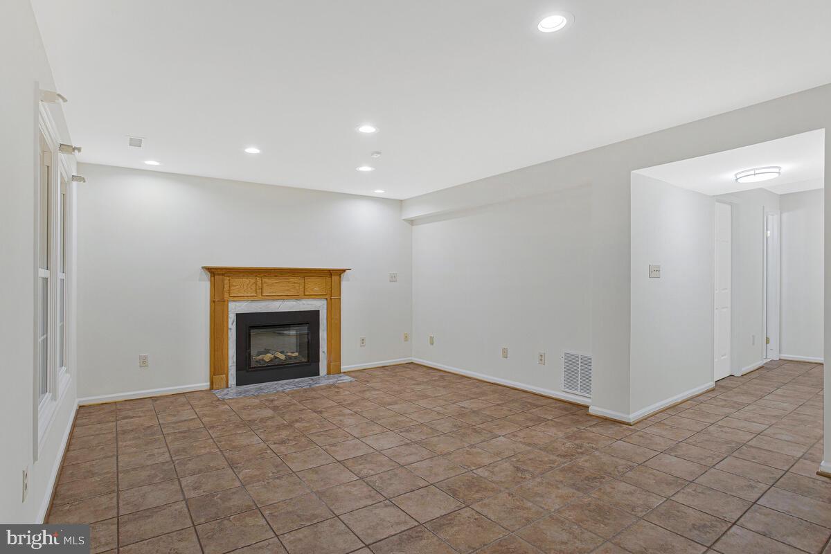 2144 Commissary Circle Odenton, MD 21113 - Photo 23 of 35 an empty room with a fireplace and cabinet