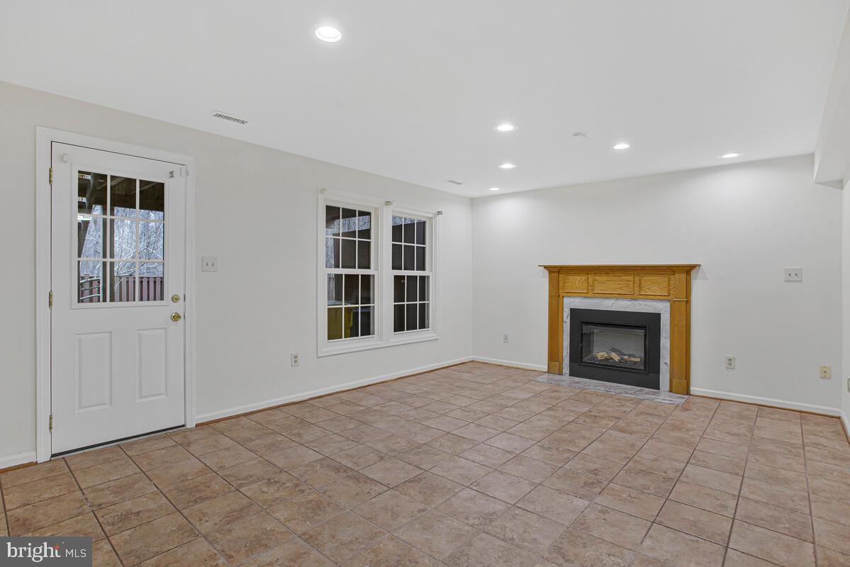 2144 Commissary Circle Odenton, MD 21113 - Photo 25 of 35 a view of an empty room with a window and fireplace