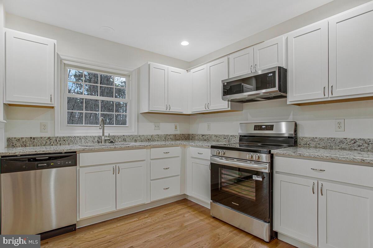 2144 Commissary Circle Odenton, MD 21113 - Photo 3 of 35 a kitchen with stainless steel appliances granite countertop a stove and a sink
