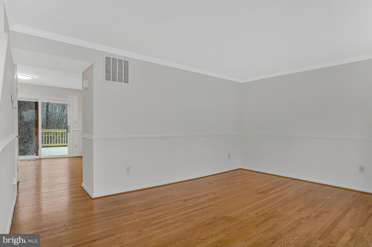 2144 Commissary Circle Odenton, MD 21113 - Photo 8 of 35 a view of an empty room with wooden floor and a window