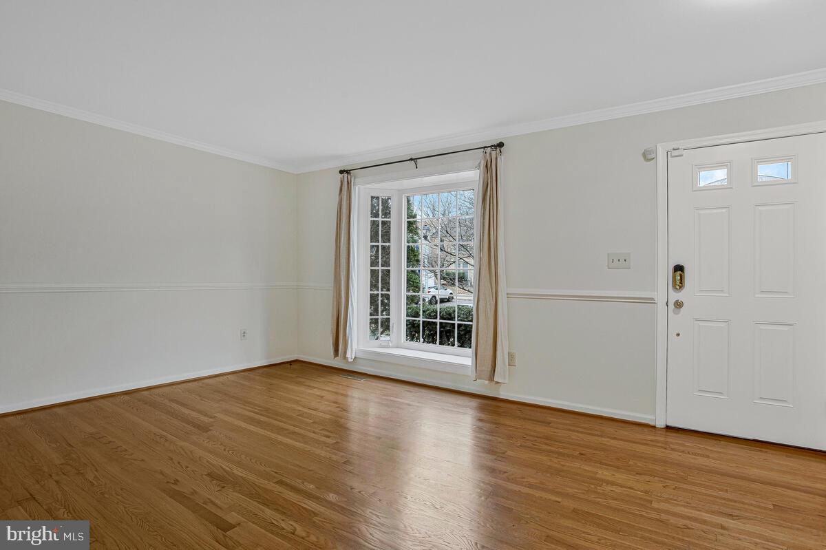 2144 Commissary Circle Odenton, MD 21113 - Photo 10 of 35 a view of an empty room with wooden floor and a window