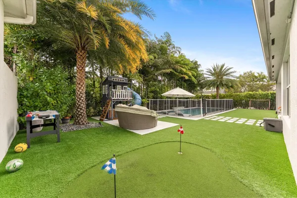 a kitchen with sink stove and living room view