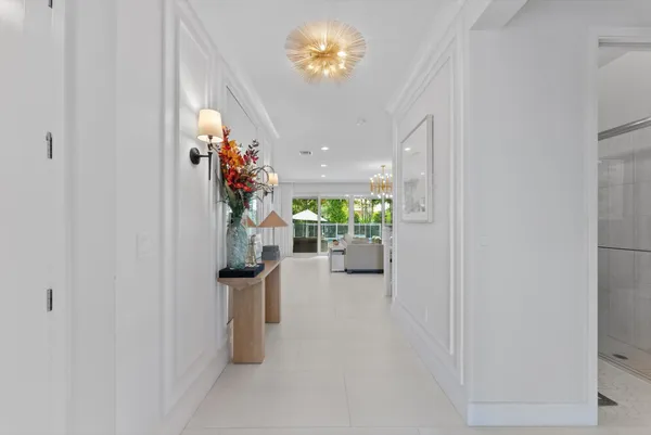 a kitchen with stainless steel appliances kitchen island granite countertop a sink a stove and a wooden floors