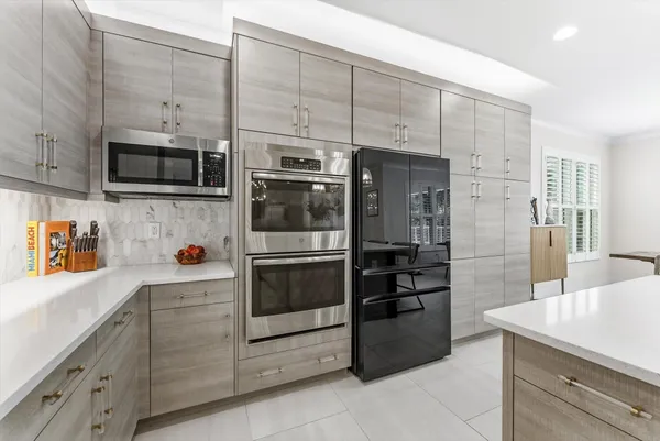 a living room with furniture a flat screen tv and a chandelier