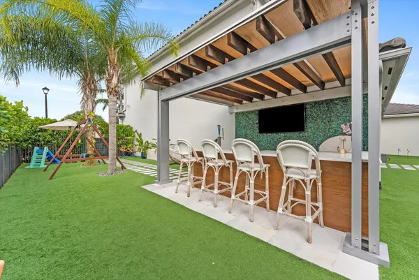 a view of a couches in a patio with a yard