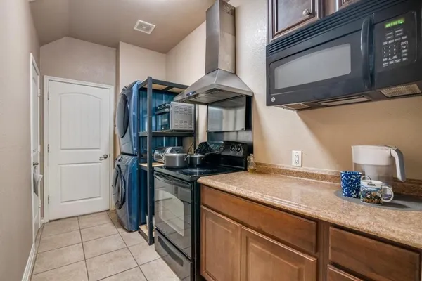 a kitchen with stainless steel appliances granite countertop a sink and a stove