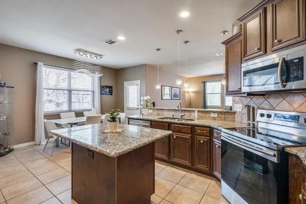 a kitchen with a sink stove and cabinets