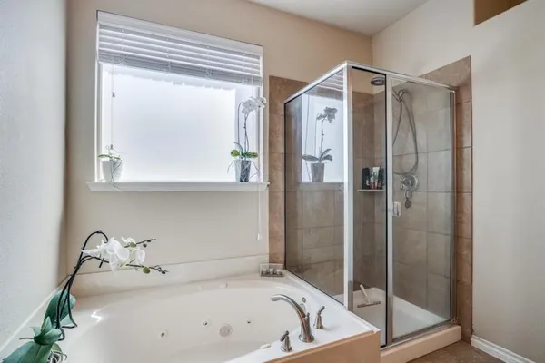 a bathroom with a tub and shower