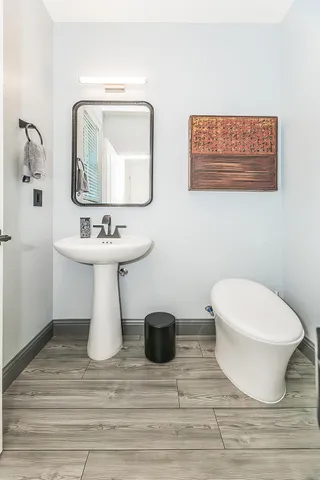 a bathroom with a double vanity sink mirror and bathtub