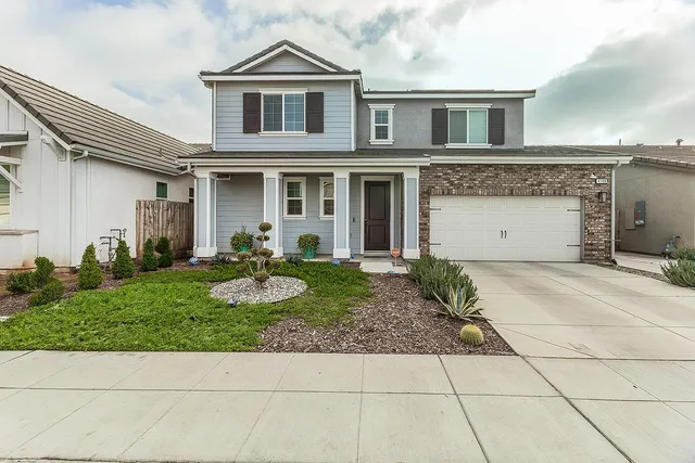 a front view of a house with garden
