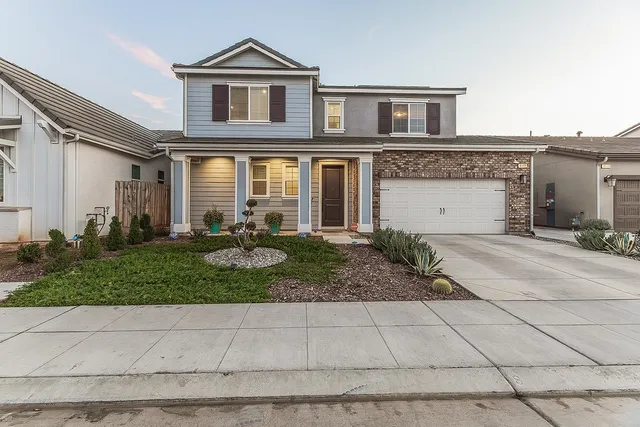 a front view of a house with a yard and porch