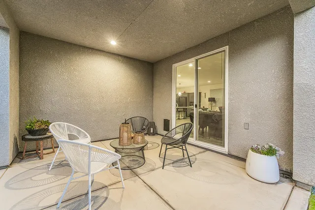 a dinning table and chairs in patio of the house