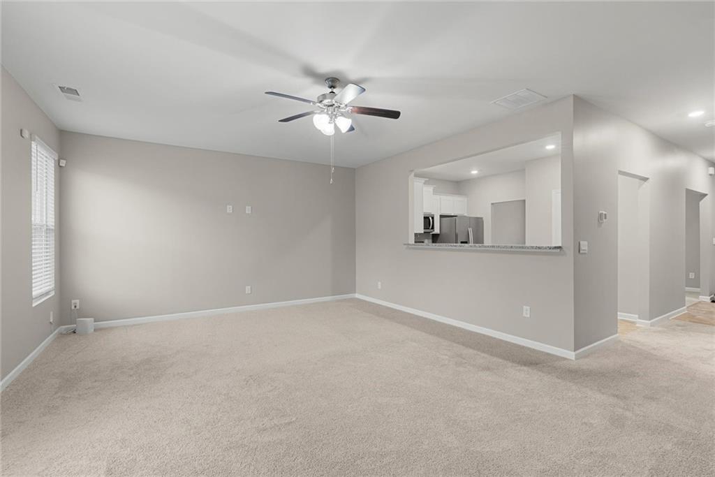 2650 Axel Ridge Decatur, GA 30034 - Photo 14 of 29 an empty room with a kitchen and a ceiling fan