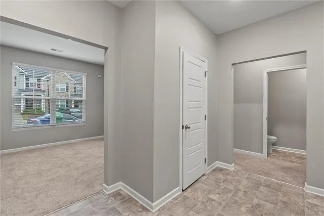 an empty room with windows and closet