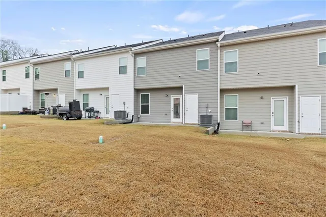 a view of a white house with a swimming pool