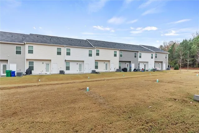 a house view with swimming pool in front of it