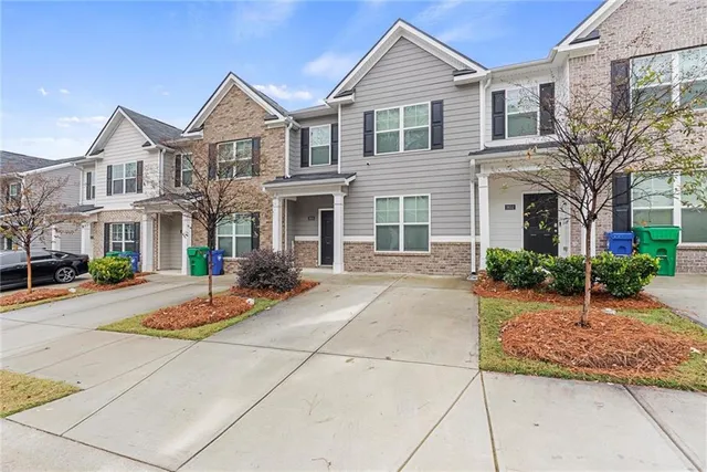 a front view of a house with yard and garage
