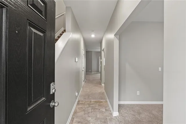 a view of a hallway with wooden floor and entryway