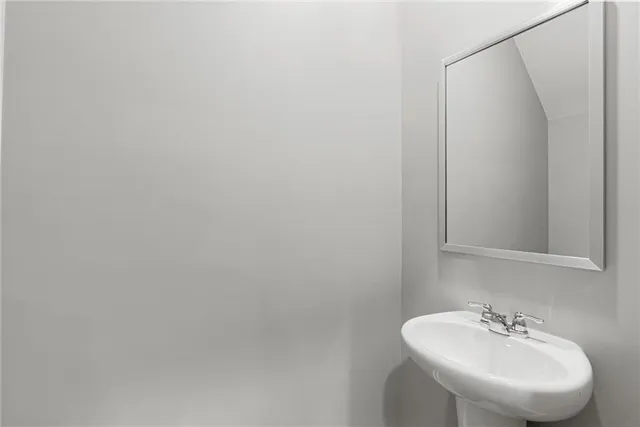 a bathroom with a sink and mirror