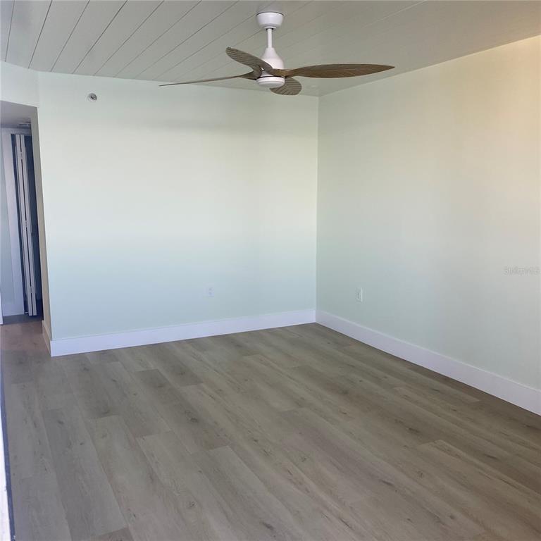 6035 Sea Ranch Drive, Unit 902 Hudson, FL 34667 - Photo 11 of 32 a view of an empty room with wooden floor