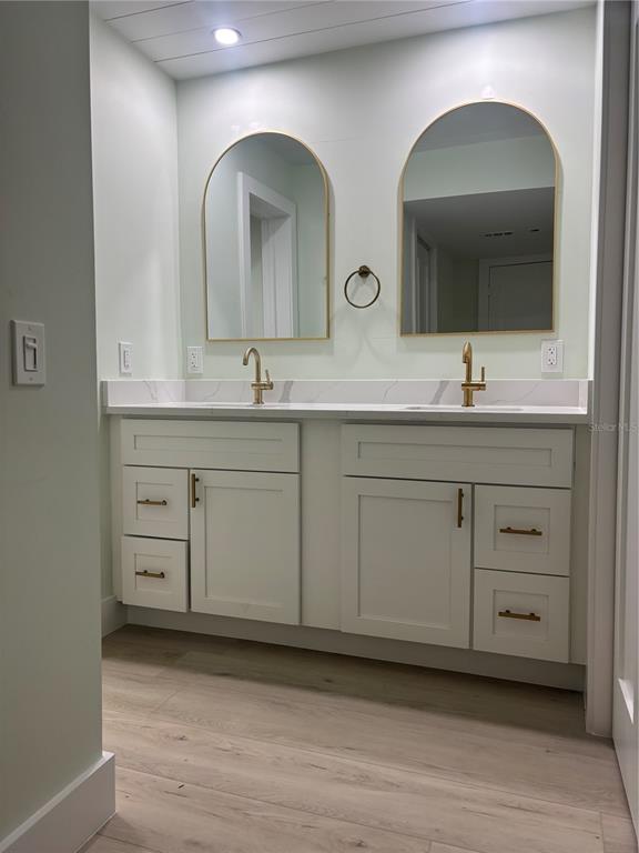 6035 Sea Ranch Drive, Unit 902 Hudson, FL 34667 - Photo 12 of 32 a bathroom with a double vanity sink and mirror