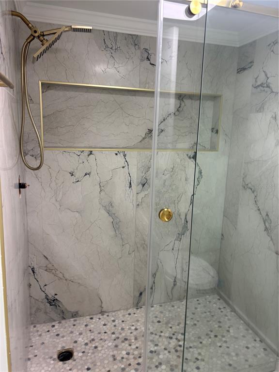 6035 Sea Ranch Drive, Unit 902 Hudson, FL 34667 - Photo 13 of 32 a bathroom with a shower