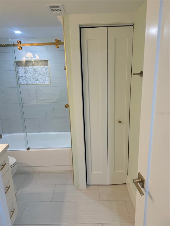 6035 Sea Ranch Drive, Unit 902 Hudson, FL 34667 - Photo 17 of 32 a bathroom with a shower and a tub