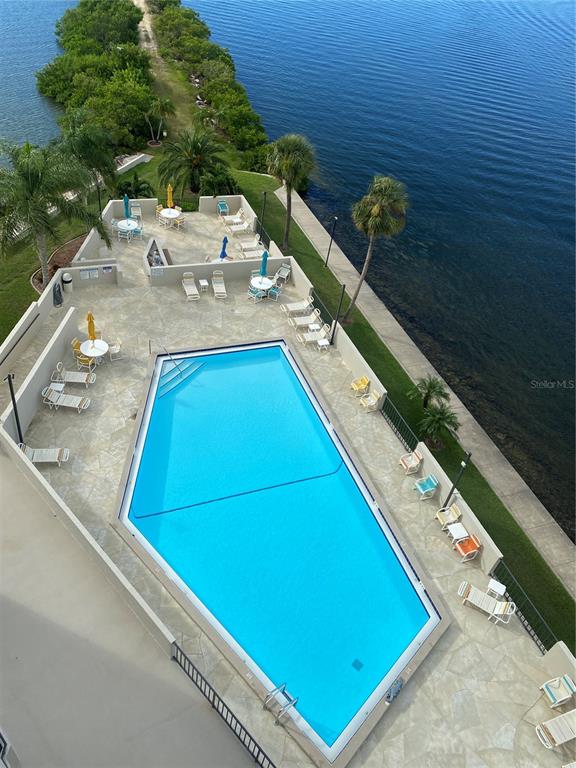 6035 Sea Ranch Drive, Unit 902 Hudson, FL 34667 - Photo 24 of 32 a view of swimming pool with chairs and wooden floor