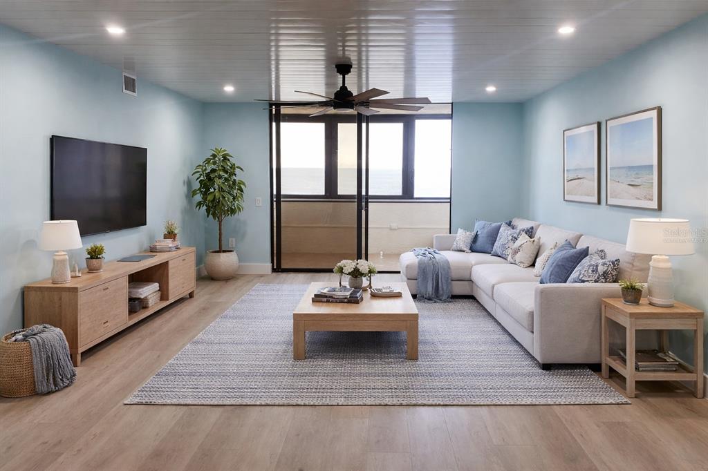 6035 Sea Ranch Drive, Unit 902 Hudson, FL 34667 - Photo 7 of 32 a living room with furniture and a flat screen tv