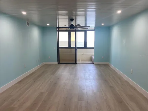 a bedroom with a large bed and a large window